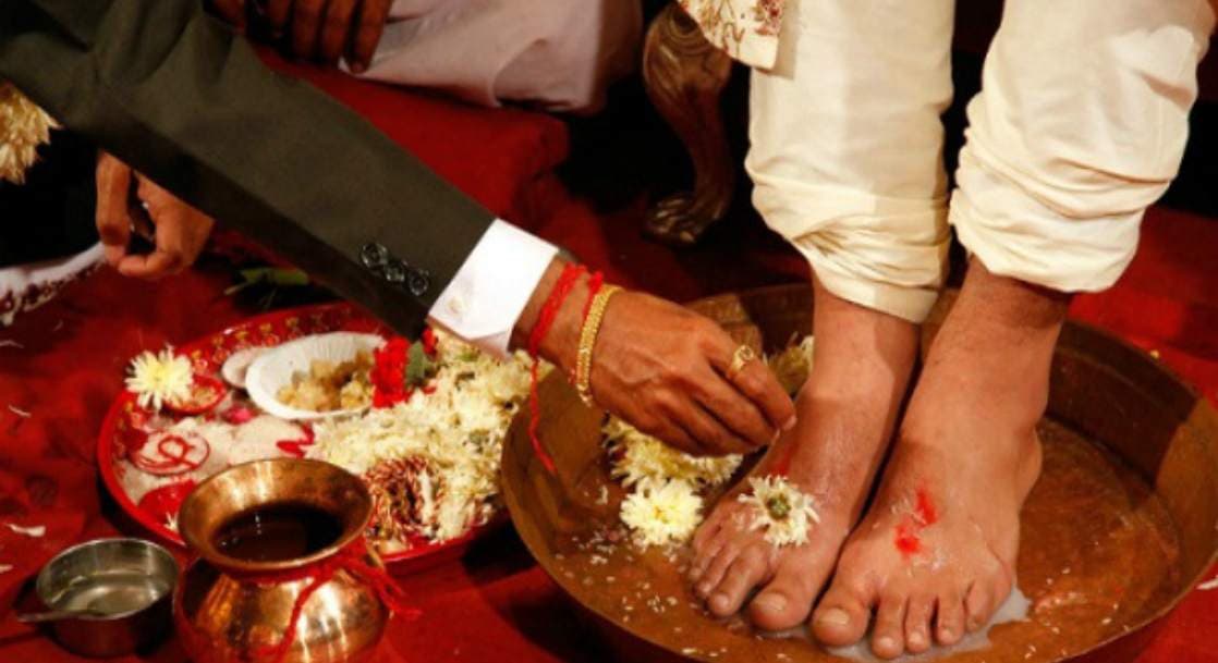 SHOWING THE IMAGE OF " Washing the groom's feet with milk and honey", ONE OF THE Shocking Indian Wedding Rituals